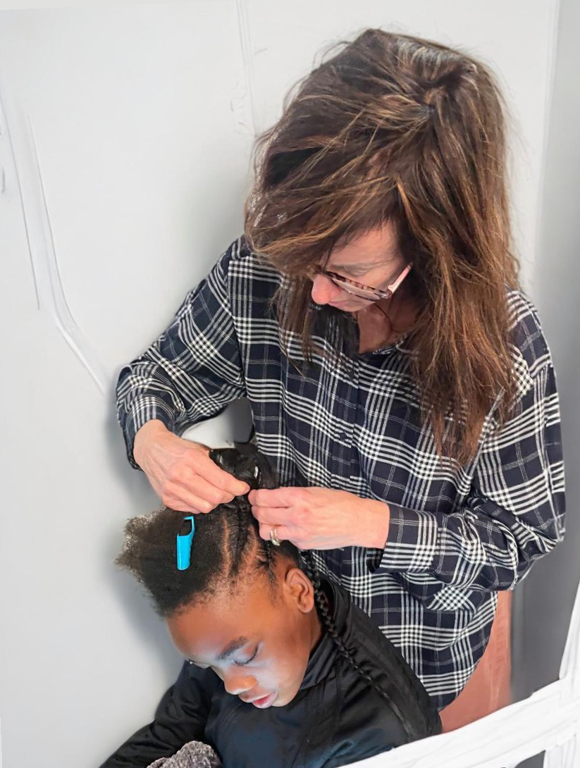 Mom braiding daughter's hair.
